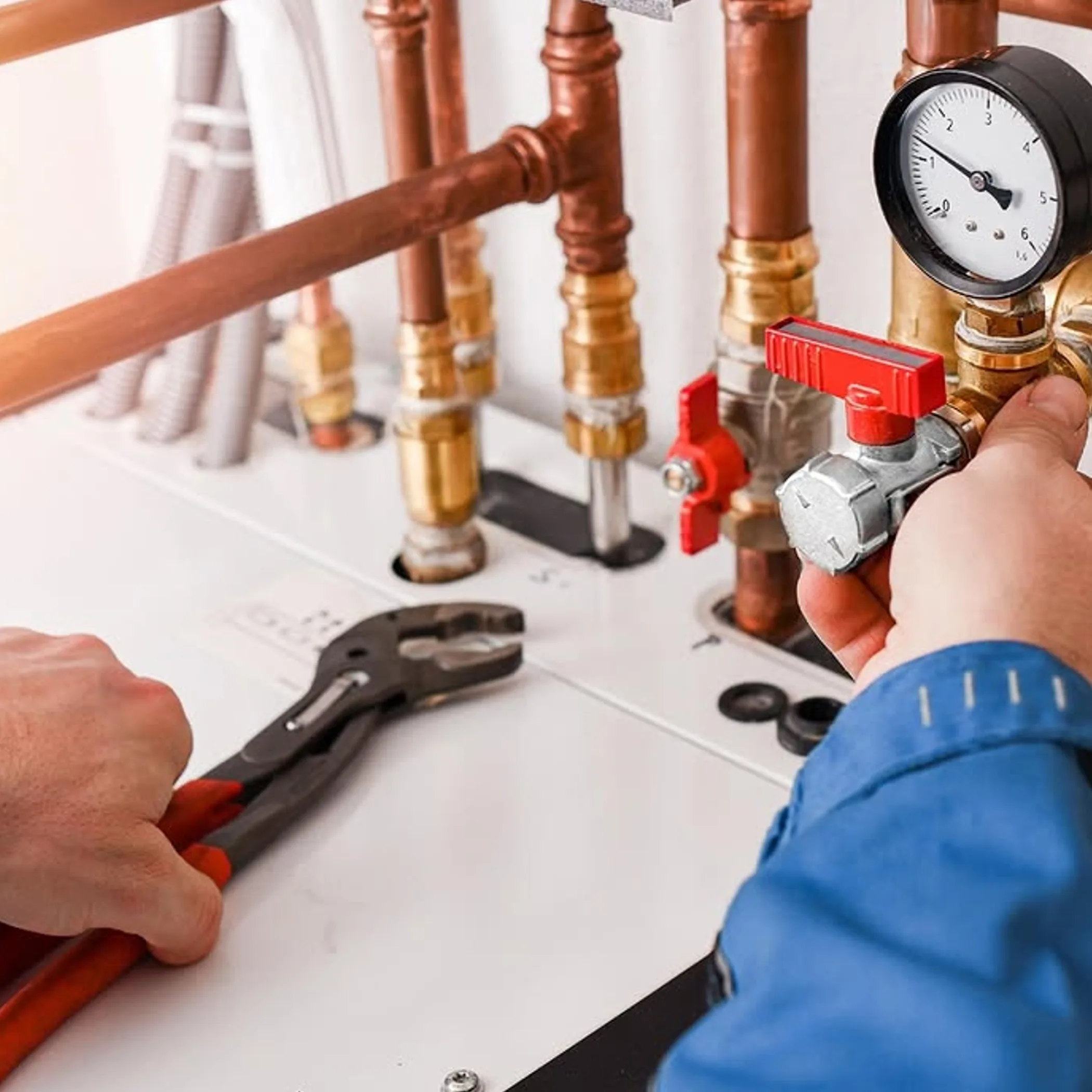technician servicing gas pipes and pressure gauge