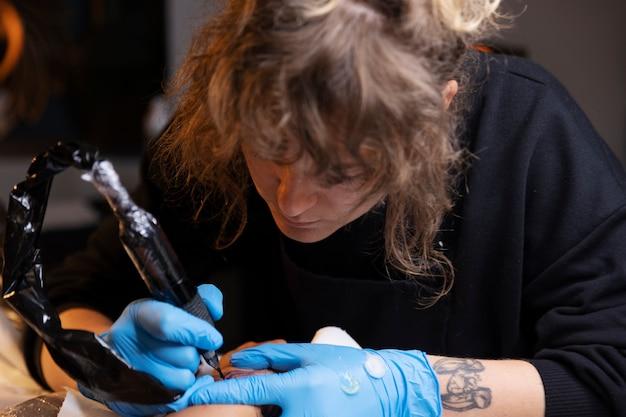 Artist in gloves crafting a sculpture with focus and precision